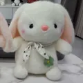 Detailed view of soft plush bunny rabbit featuring polka-dot scarf and flower charm - 22cm / White