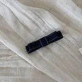 Macro view of a dark blue denim bow hair clip with white stitching on linen fabric. - Dark Blue Denim - Double Layer Bow Hair Clip