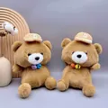 Detail shot of two cute brown plush teddy bears with colorful bells in a cozy setup - Bear / 23cm
