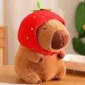 Adorable capybara plush toy with a red strawberry hat detail shown on a wooden table - Strawberry Headgear Capybara Style / Approximately 23cm