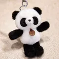 Detailed macro view of a cute black and white fluffy panda plush keychain charm. - Panda