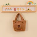 Detailed view of a cute brown plush Capybara tote bag hanging on a cozy wall shelf display - Orange Fruit Embroidery Style / 25cm