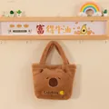 Cute brown Capybara plush handbag hanging on a decorative wall rack - Yellow Fruit Embroidery Style / 25cm
