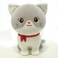 Adorable grey and white plush cat toy with a red polka-dot scarf in a sitting pose. - Gray Cat