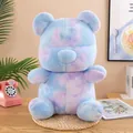 Adorable colorful tie-dye plush teddy bear toy presented in a cozy home lifestyle setting - 24cm / Purple Multi