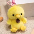Close-up detail of a soft yellow fuzzy chick plush animal keychain with a pink carabiner clip - 12cm / Chicken