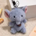 Macro view of a soft blue plush elephant toy charm with a silver clip and leather tag - 12cm / Elephant