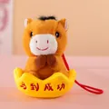 Close-up detail of plush horse mascot keychain sitting in a yellow gold ingot for luck - 12cm / Brown