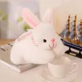 Detailed macro view of a white plush rabbit toy with polka dot ribbon in a cozy setting - 25cm / White