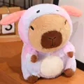 Cute capybara plush toy wearing a pink gradient costume on a wooden desk - Capybara Dog Costume / 23cm