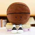 Adorable plush basketball doll with a smiley face and legs sitting on decorative books - 25cm (Small) / Basketball