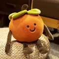 Close-up of creative persimmon plush toy with smiley face and long limbs on ottoman - Persimmon with Legs / 35cm
