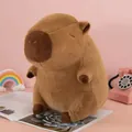 Adorable brown capybara plush toy sitting on a desk with cute pink pastel accessories - Classic Style / Height 23CM