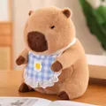 Cute capybara plush toy wearing a blue checkered bib on a wooden table indoor scene - Blue Bib Style / Height 23CM