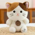 Detailed view of cute tricolor cat plush toy with Anyagi Petban wooden tag on a mat - 16cm / Calico Cat