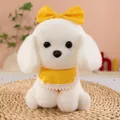White Bichon plush toy dog wearing a yellow bow and bib, sitting on a woven mat - White / 23cm