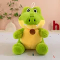 Close-up view of a cute green crocodile plush toy with soft fur and a small brown brand tag. - Crocodile / 23cm