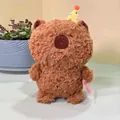 Detail shot of a brown plush capybara toy wearing a yellow polka dot party hat - Capybara Style / 23cm