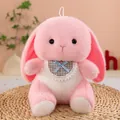 Close-up detail of an 8-inch cute pink plush bunny toy with a decorative blue bib. - Bib Bunny / 23cm