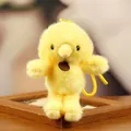 Detailed view of a fluffy yellow chick plush toy keychain on a wooden frame. - Yellow Chicken