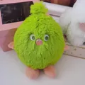 Detail shot of a vibrant green fluffy monster plush toy with soft pink limbs and feet - Green / 25cm