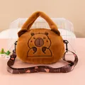 Adorable brown plush capybara handbag with embroidered face and adjustable shoulder strap. - Praying Capybara