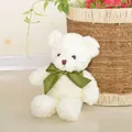 Adorable white teddy bear plush toy with a green bow in a cozy home setting - White Ribbon Bear / 27cm