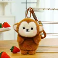Close-up of a cute brown plush monkey keychain accessory on a wooden desk with strawberries - Monkey / 18cm (With Lanyard)