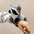 Close-up detail of a cute plush raccoon slap bracelet worn on a person's wrist - 15cm / Grey Raccoon