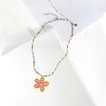 Handgefertigte bunte Perlenkette mit einem leuchtend rosa-gelben Gänseblümchen-Anhänger - Rosa Blume