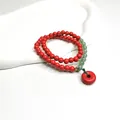 Doppelreihiges zinnoberrotes Perlenarmband mit grünen Akzenten und rotem Anhänger. - Friedensschnalle-Anhänger (5665728761864) / Rot
