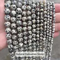 Vue détaillée de perles rondes en jaspe dalmatien naturel en plusieurs tailles pour DIY. - 4mm (Env. 90 pcs/brin) / Pierre naturelle dalmate