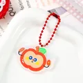 Close-up detail of a cute cartoon apple acrylic keychain with vibrant red bead chain - Cheering Apple (2088)