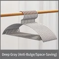 Dark grey seamless non-slip clothes hangers with anti-shoulder bump curved design for closet. - Gray