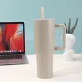Detail of a matte beige 40oz insulated stainless steel tumbler with straw on office desk. - 40oz / Dark Khaki