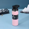 Detail of pink stainless steel insulated sports bottle with carry handle on blue background - 550ml / Pink