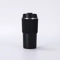 Detailed side view of a minimalist black stainless steel vacuum insulated coffee cup - 500ml / Black