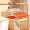 Non-slip clothes hangers in orange and white with neck-protection design. - Neck Protection Style / Orange