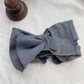Close-up of a vintage grey ribbed cotton headband with a large bow detail - Dark Grey