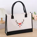 Detailed view of canvas tote bag with cute reindeer print and black handles - Antler