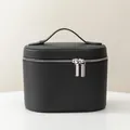 Elegant black pebble leather handheld makeup bag with silver double zippers for travel. - Black