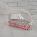 Detailed view of portable transparent cosmetic bag with colorful woven chevron base - 15x7x14CM / Wave