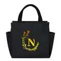Detailed front view of black insulated lunch bag with yellow floral N initial logo - Gold Gradient Letter N / Black