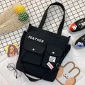 Versatile black canvas crossbody bag for women featuring multiple front pockets and top handle - Black