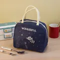 Borsa termica blu scuro con motivo a pesci e scritta 'Wonderful' appoggiata su un tavolo. - Blu Notte