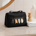 Large black portable toiletry bag with cute hanging cat print on a bathroom vanity counter - Black
