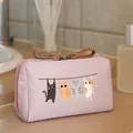 Pink travel makeup bag featuring a cute hanging cat cartoon illustration - Pink
