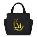 Portable black insulated lunch bag featuring a stylish yellow floral monogram M design - Gold Gradient Letter M / Black