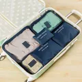 A 6-piece travel packing cube set in navy, pink and green organized in a suitcase. - 6-Piece Set / Navy Blue