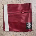 Durable maroon foldable travel storage bag featuring front zipper and mountain logo patch - Airplane Bag / Fuschia
